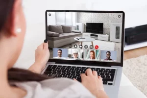A imagem mostra um homem em uma reunião online vendo a sala de um apartamento. Foto para ilustrar o texto sobre tour virtual para imobiliárias